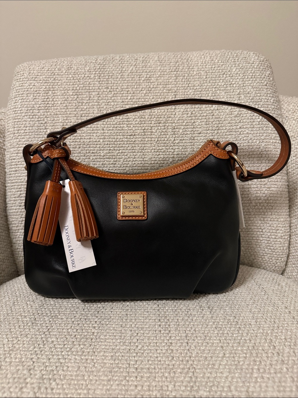 Dooney & Bourke Black Leather Shoulder Bag with Brown Trim and Tassels